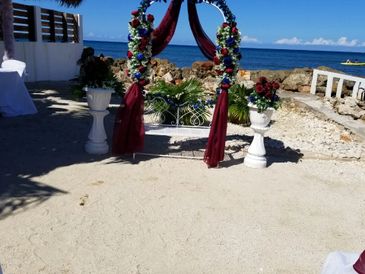 crown wedding arch for marriage ceremony on beach.