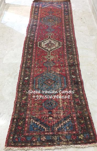 Antique wool carpet runner with signs of age. Red, Blue, Brown and Yellow.