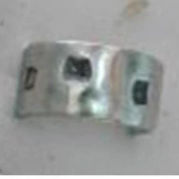 Silver ring with black squares embedded in plaster