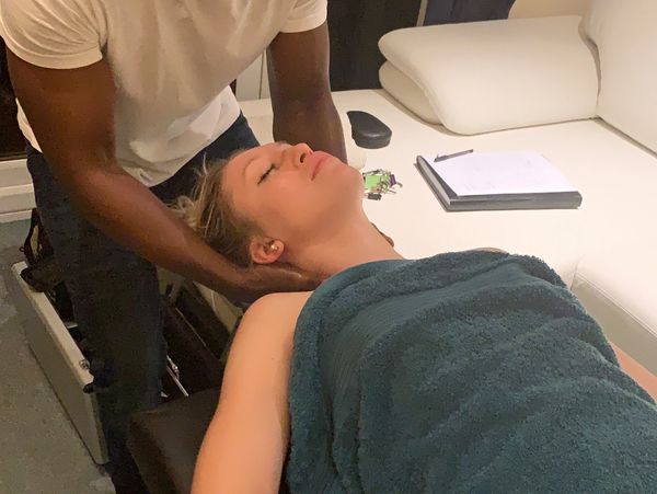A massage therapist offering a neck massage