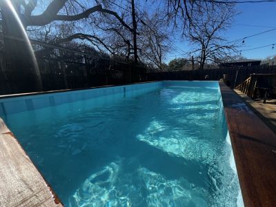 Finished custom shipping container pool installed at a Central Texas property
