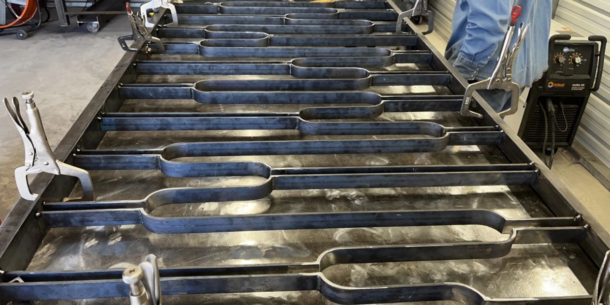 Metal frame structure being constructed with clamps.