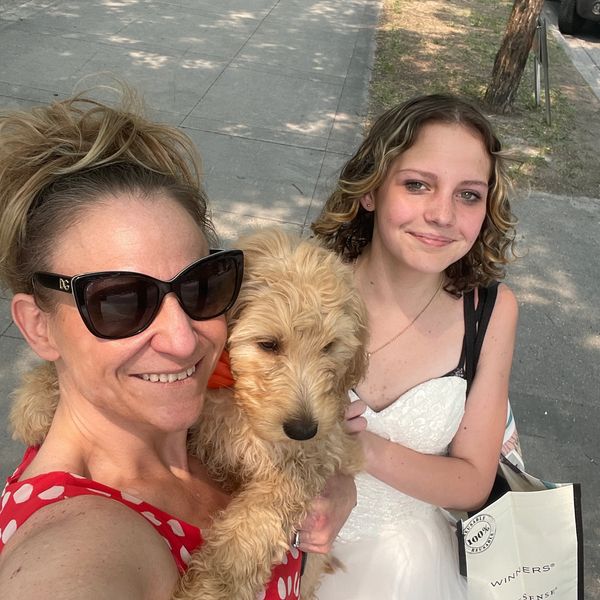 Shannon FOUNDER & CEO of ColioCo Doodles delivering a Calgary Goldendoodle puppy with my daughter