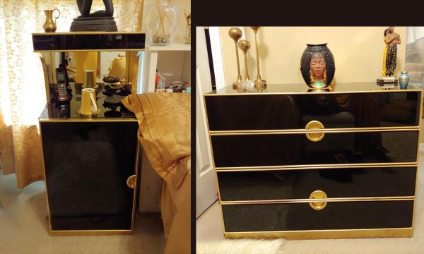 Black and gold furniture with decorative items on top.