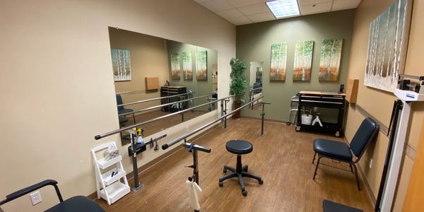 Image of the Gait Room, equipped with a walking pitch with two bars to hold onto and test devices