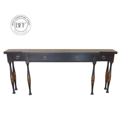 Long wooden console table with elegant turned legs and multiple drawers.