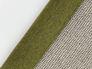 Close-up of two textured fabrics, one olive green labeled 'Jungle' and the other beige.