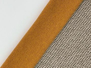 Close-up of two fabric swatches, one mustard yellow and one textured gray, labeled 'Laguna'.