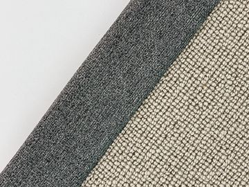 Close-up of three different fabric textures in neutral colors arranged diagonally.