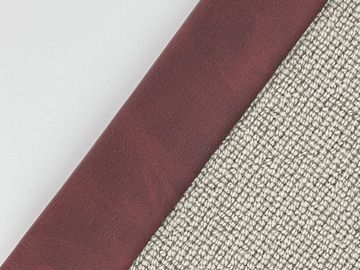 Diagonal view of berry-colored leather and textured fabric.