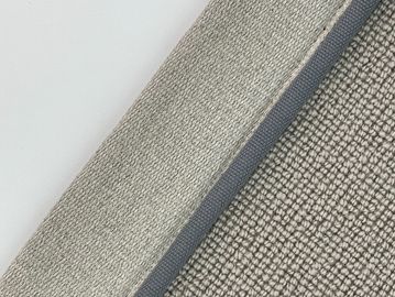 Close-up of textured beige fabric labeled 'Fossil'.