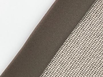 Close-up of layered fabrics in white, brown, and textured beige.