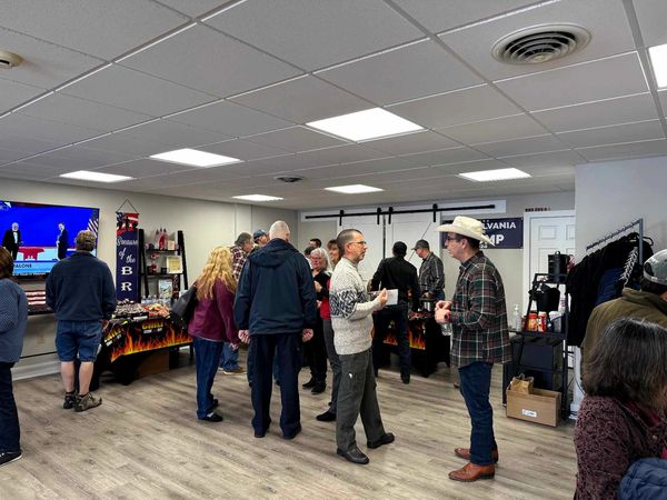 Chili Cook-Off
Candidate for Sheriff John Wega (hat) speaking with an attendee.