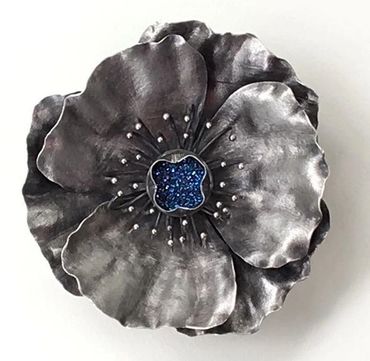 Sterling Silver poppy pin-pendant with a Titanium druzy center stone.