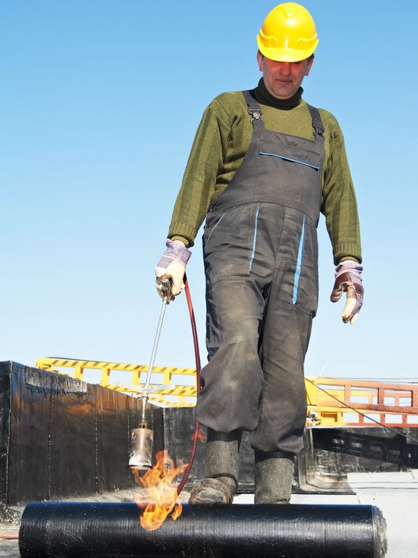 Nashville's Best Commercial Roofing Company
Man rolling out roofing material and heating it up