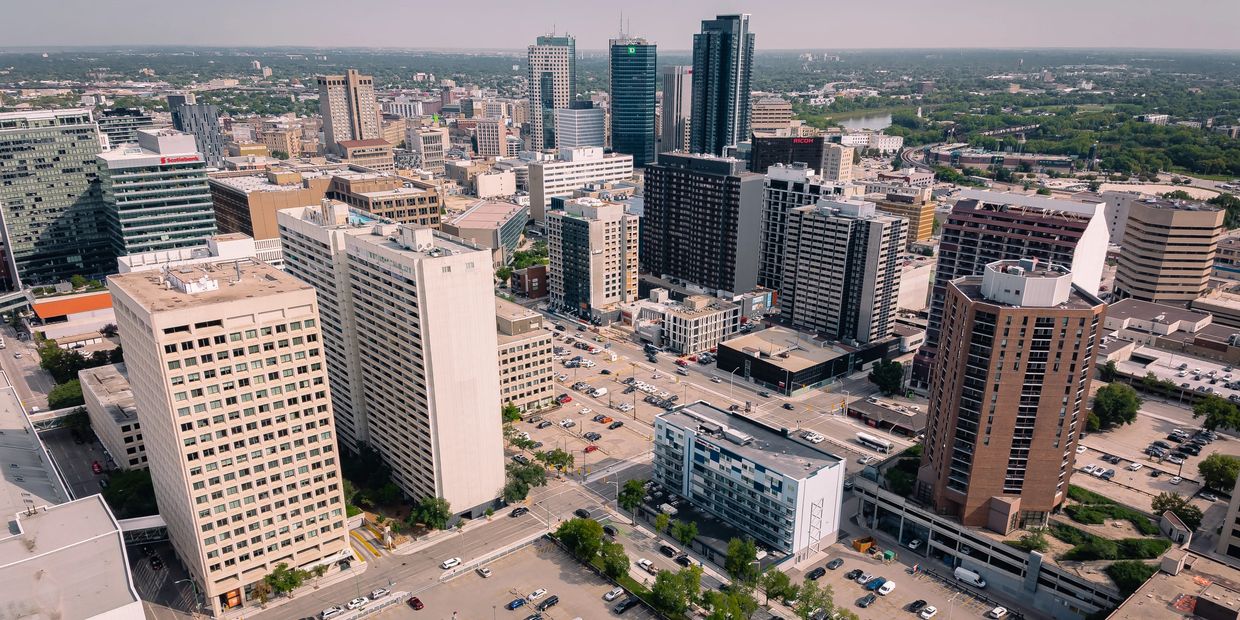 Aerial view of downtown Winnipeg with Hampton by Hilton logo.