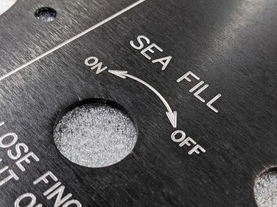 Custom engraved stainless steel equipment panel by Industrial Engravers.