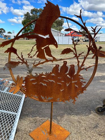 Eagle feeding chicks sculpture