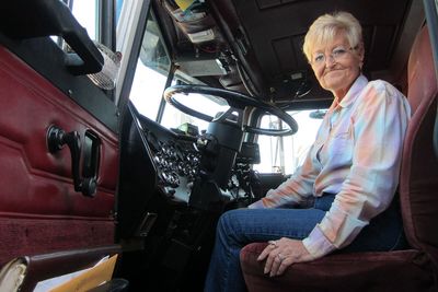 a woman sitting in the drivers seat of a truck