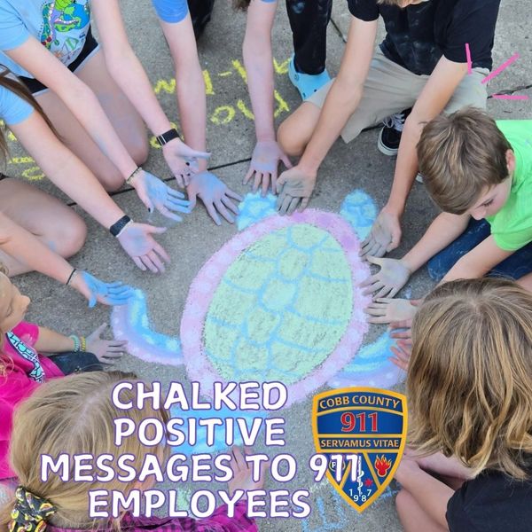 Positive Sidewalk Chalk for Cobb County 911 Dispatchers created by KIDS CARE volunteers.
