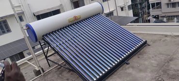 A solar water heater with multiple blue tubes on a rooftop.