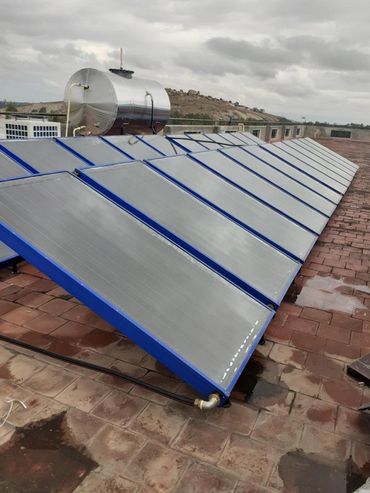 Commercial solar water heaters installed on a rooftop.