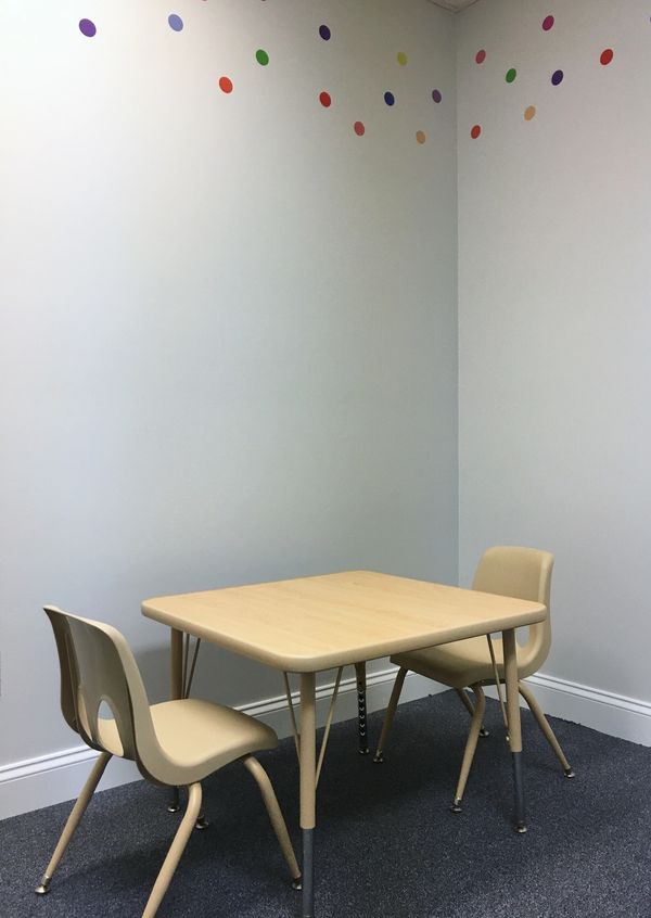 Small table with chairs and colorful wall border