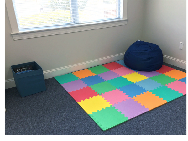Floor mat with box of books and bean bag