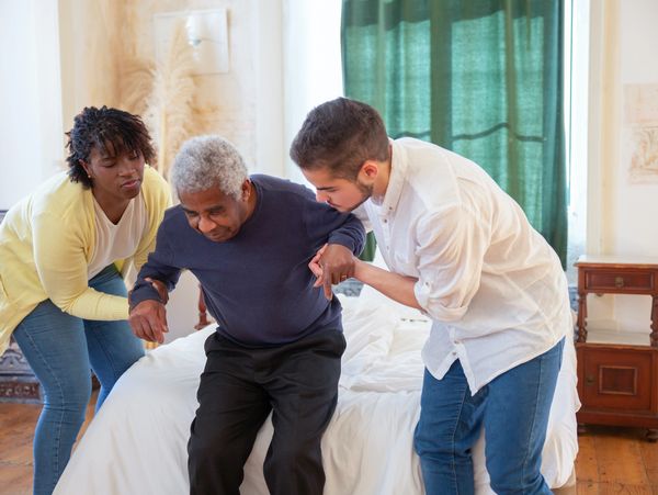 Senior patients being assisted by physical therapist.