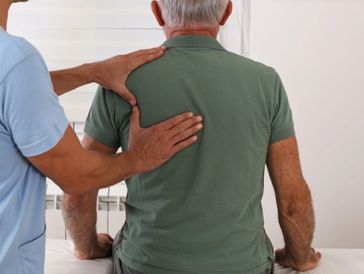chiropractor adjusting patient