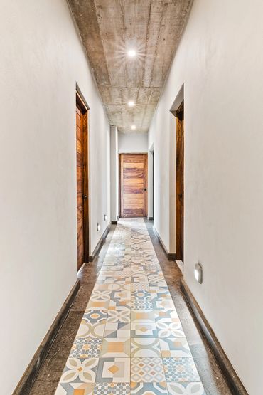 Tiled Hallway leading to Bedrooms and Bottom Decks
