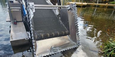 SM301 Diesel SM-301 Diesel Eco-Harvester with Sickle Head Attachment at Boat Launch Landing on Lake.