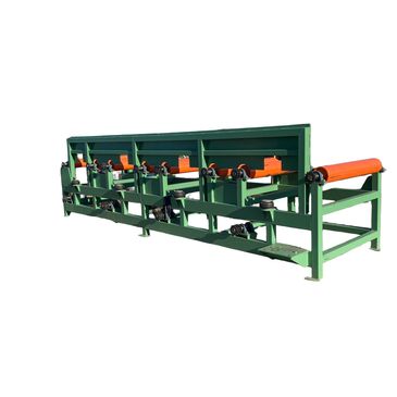 Green industrial conveyor belt system with orange rollers.