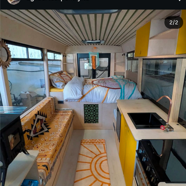 Cozy camper interior with bright yellow accents and patterned textiles.