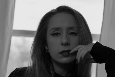 Black and white portrait of a woman with a contemplative expression.