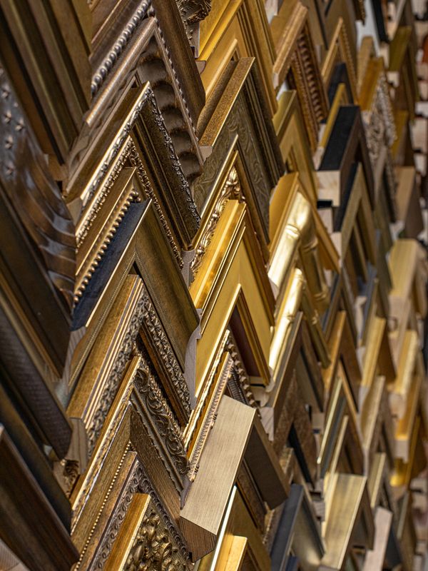 Collection of premium frame samples showcasing a variety of gold styles and expert craftsmanship.