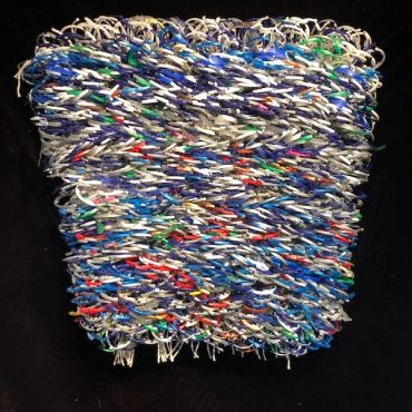 Colorful woven basket with mixed materials.