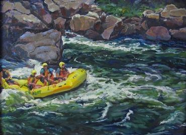 A group rafting on a river surrounded by rocks.