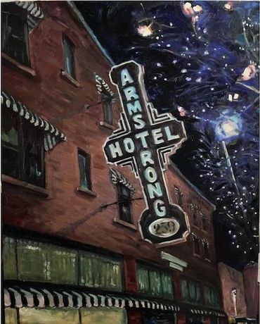 Nighttime street view of a hotel with a glowing vintage neon sign.