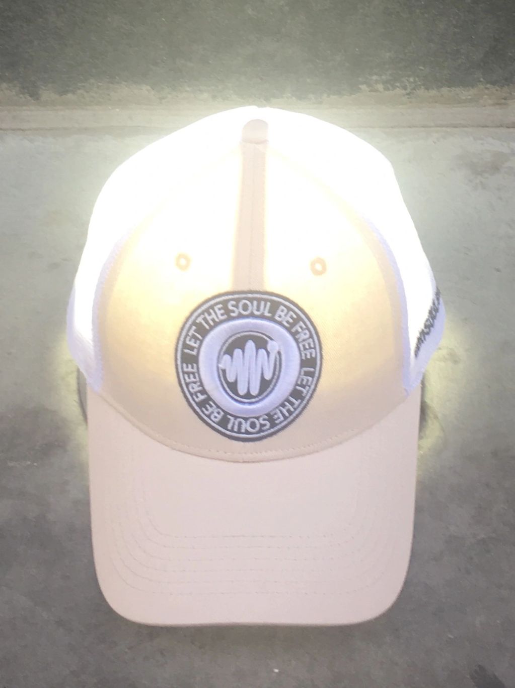 A light on the floor shining through a conSOULscious cap