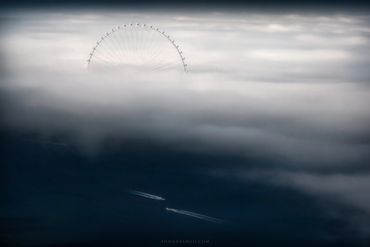 ain dubai the world's largest ferries wheel covered with fog and boats passing fine art ahmad alnaji