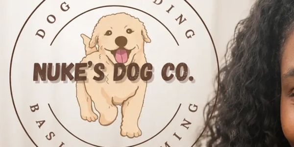 Logo of Nuke's Dog Co. featuring a happy dog illustration.