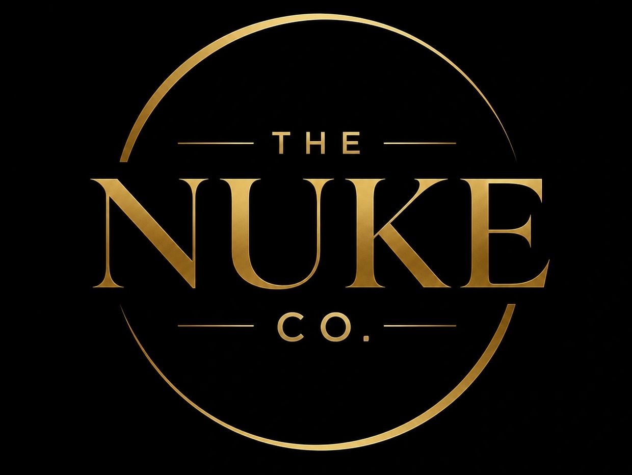 Elegant gold logo of The Nuke Co. on black background.