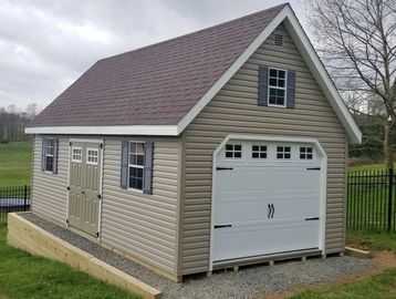 vinyl 2 story garage with wooden floor