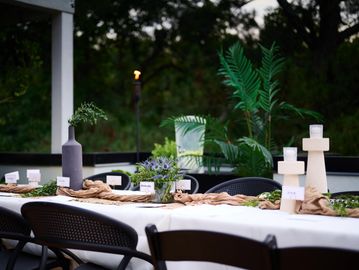Elegant outdoor dining table set at dusk.