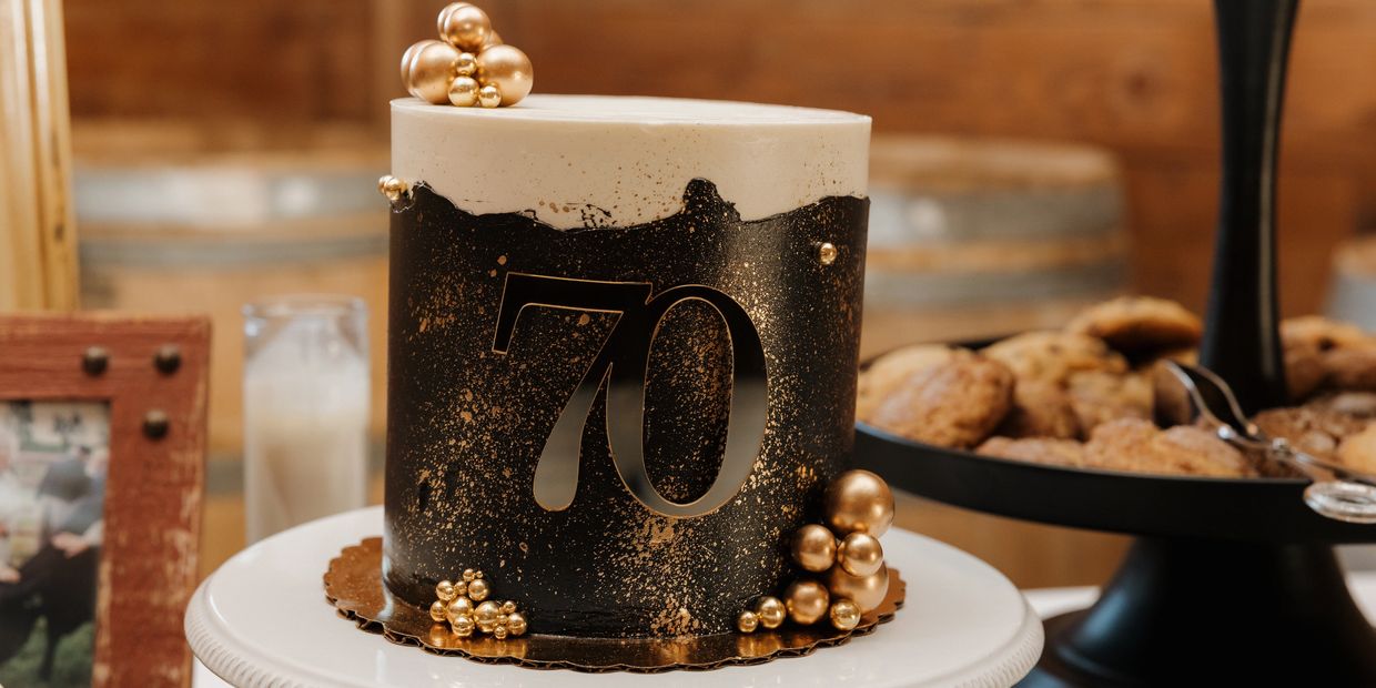 Elegant black and gold 70th birthday cake.