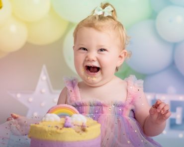 baby girl smiling during her photoshoot