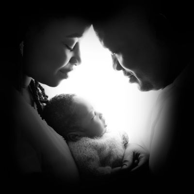 Parents holding a newborn baby during a professional photoshoot