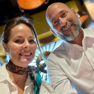 Smiling couple in a warm-lit setting.