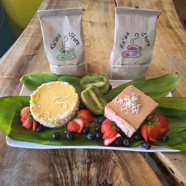 Two coffee bags with desserts and fruit on a wooden table.